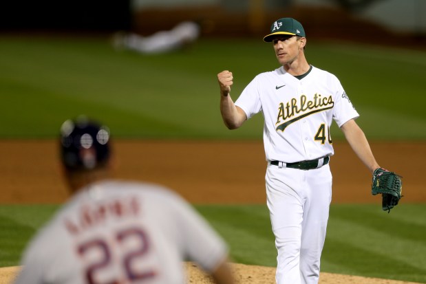 OAKLAND, CA - APRIL 1: Oakland Athletics starting pitcher Chris Bassitt (40) pumps his fist after Oakland Athletics' Chad Pinder (4) made a diving catch on a line drive by Houston Astros' Jose Altuve (27) in the fifth inning of their American League game on Opening Day at the Oakland Coliseum in Oakland, Calif., on Thursday, April 1, 2021. (Ray Chavez/Bay Area News Group)