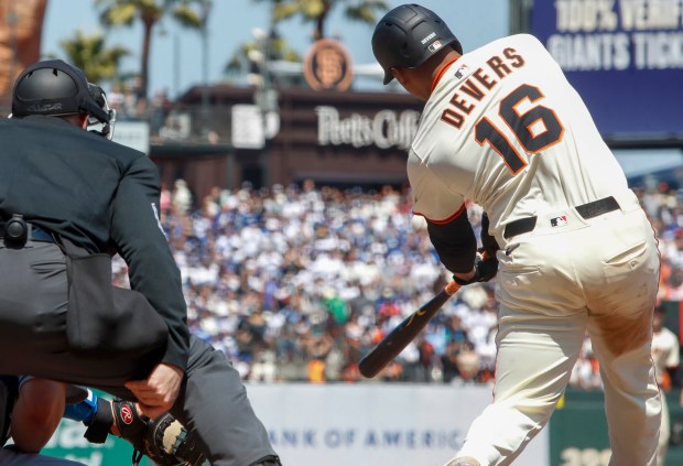 San Francisco Giants' Rafael Devers (16) hits a sacrifice fly against the Los Angeles Dodgers in the eighth inning at Oracle Park in San Francisco, Calif., on Saturday, July 12, 2025. (Shae Hammond/Bay Area News Group)