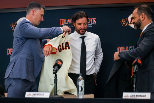 San Francisco Giants President of Baseball Operations, Buster Posey, left, and General Manager Zack Minasian, right, introduce the new San Francisco Giants manager, Tony Vitello, during a press conference at Oracle Park in San Francisco, Calif., on Thursday, Oct. 30, 2025. (Ray Chavez/Bay Area News Group)