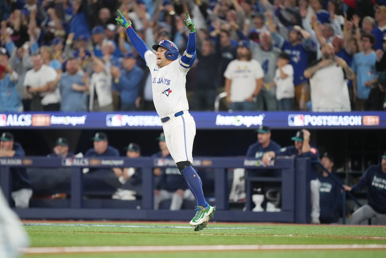Toronto Blue Jays' George Springer celebrates after hitting a three-run home run against the Seattle Mariners during the seventh inning in Game 7 of baseball's American League Championship Series in Toronto, Monday, Oct. 20, 2025. (Nathan Denette/The Canadian Press via AP)