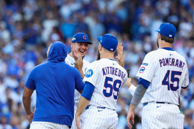 Cubs pitcher Brad Keller (40) celebrates with teammates after getting...