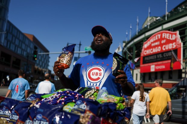 Vendor Marcus Lyons sells nuts outside of Wrigley Field before...