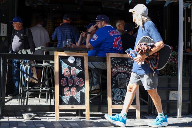 Fans sit outside Wrigley Field before Game 1 of the...
