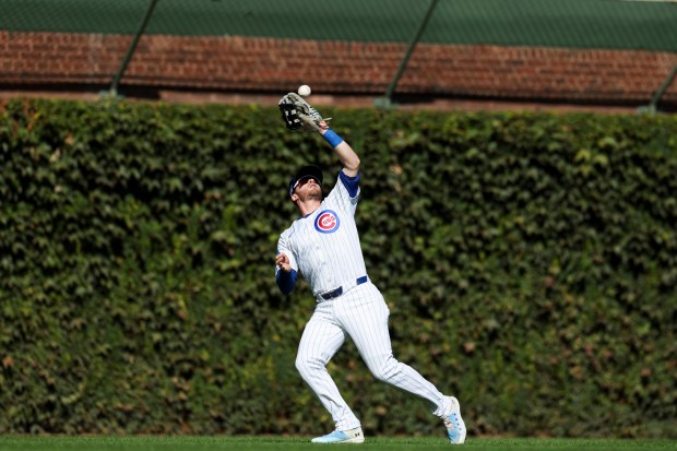 Chicago Cubs outfielder Ian Happ catches a fly ball during...