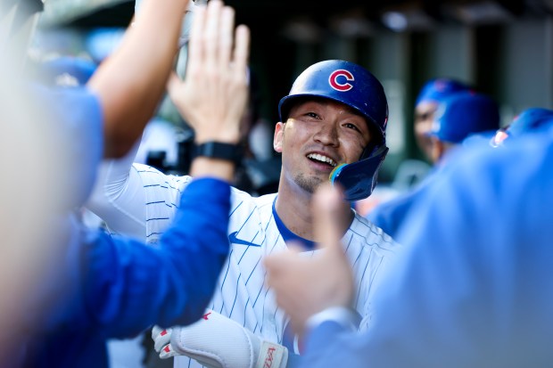 Chicago Cubs outfielder Seiya Suzuki celebrates with teammates after hitting...