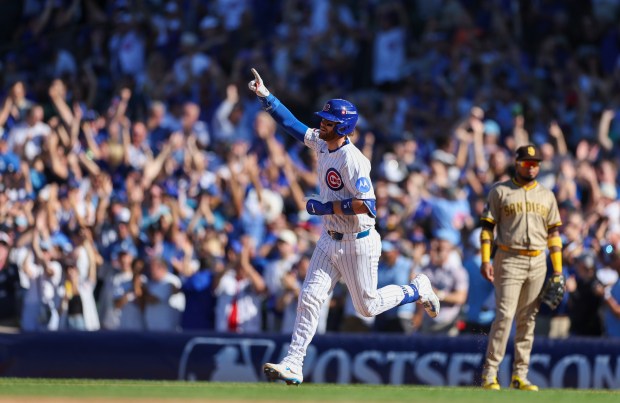 Cubs catcher Carson Kelly celebrates as he rounds the bases...