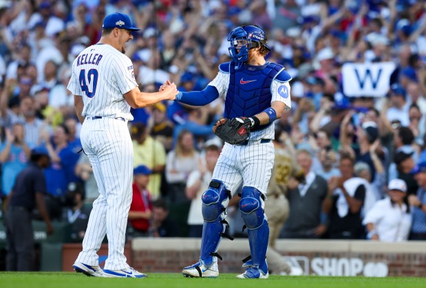 Chicago Cubs relief pitcher Brad Keller celebrates with catcher Carson...
