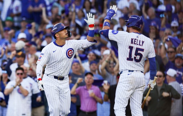 Cubs outfielder Seiya Suzuki, left, celebrates with catcher Carson Kelly...