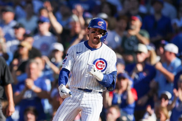 Cubs second baseman Nico Hoerner celebrates after hitting a single...