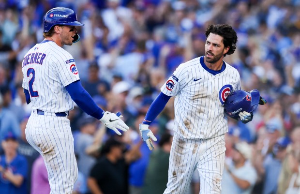 Cubs shortstop Dansby Swanson, right, and second baseman Nico Hoerner...