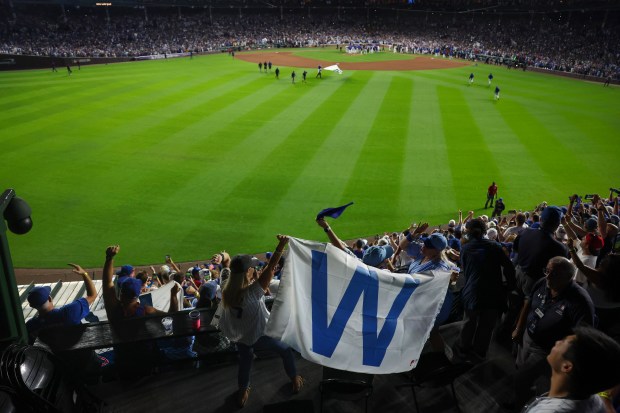 The "W" flag flies in the bleachers as the Cubs...