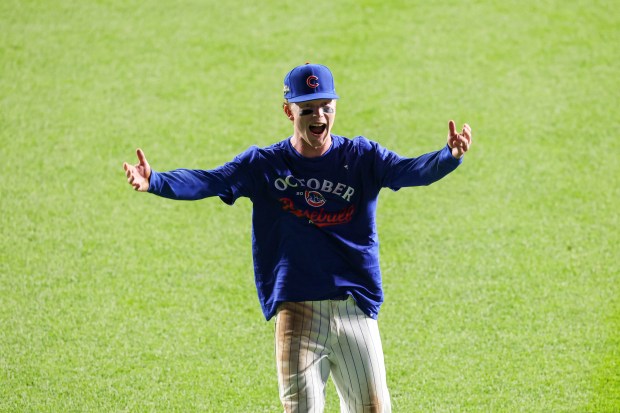 Cubs outfielder Pete Crow-Armstrong celebrates with fans in the bleachers...