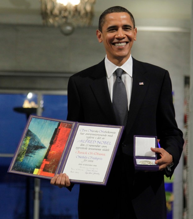 In this Dec. 10, 2009, file photo, President and Nobel Peace Prize laureate Barack Obama poses with his medal and diploma at the Nobel Peace Prize ceremony at City Hall in Oslo. (John McConnico/AP)