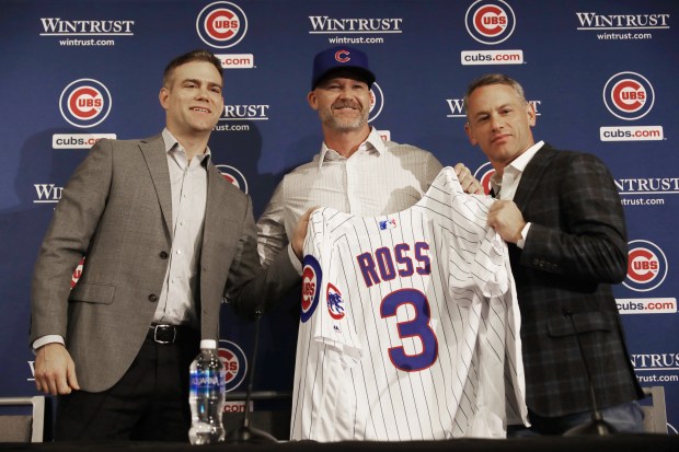 Chicago Cubs President of Baseball Operations Theo Epstein, from left, new Chicago Cubs manager David Ross and Jed Hoyer, general manager, pose for photographs at the American Airlines Conference Center next to Wrigley Field on Oct. 28, 2019, in Chicago (John J. Kim/Chicago Tribune)