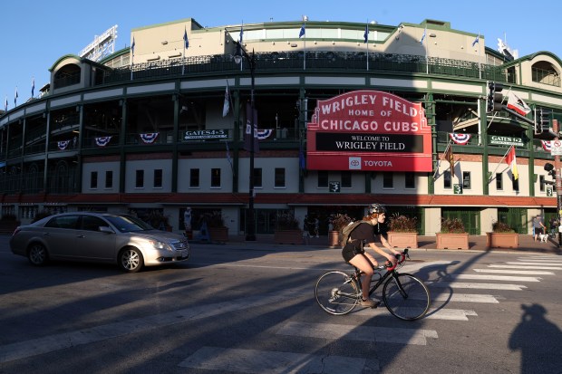 A cyclist rides past Wrigley Field on Sept. 29, 2025,...