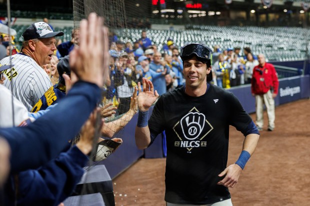 Brewers outfielder Christian Yelich celebrates with fans after a 3-1...