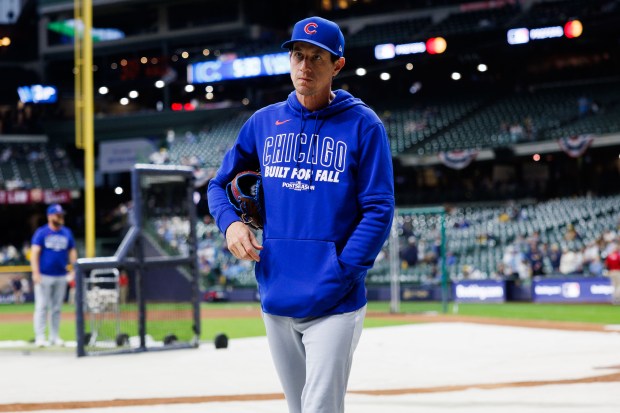 Manager Craig Counsell walks on the field before the Cubs...