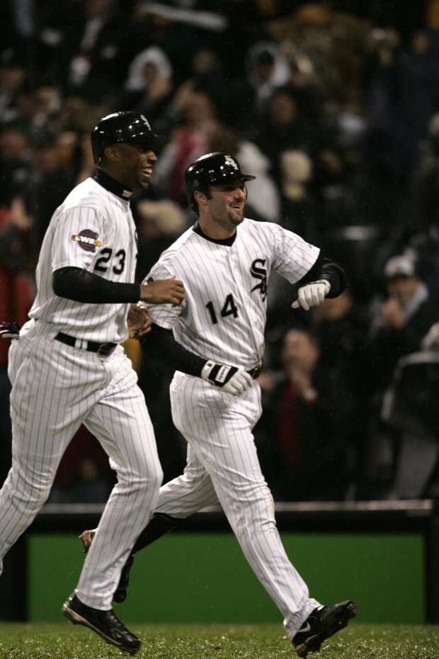 Paul Konerko (14) heads to the dugout with teammate Jermaine Dye (23) after hitting a grand slam in the seventh inning during Game 2 of the World Series against the Houston Astros on Oct. 23, 2005 at U.S. Cellular Field in Chicago. (Scott Strazzante/Chicago Tribune)