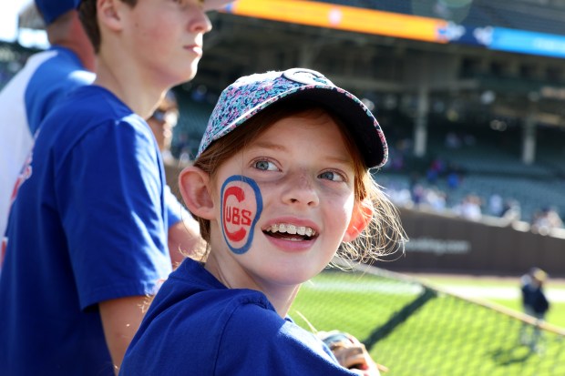 Harper Ricker, 10, of Johnson City, Tennessee, takes in the scene in the bleachers ahead of Game 3 of the NL Division Series between the Cubs and the Brewers at Wrigley Field in Chicago on Oct. 8, 2025. (Chris Sweda/Chicago Tribune)