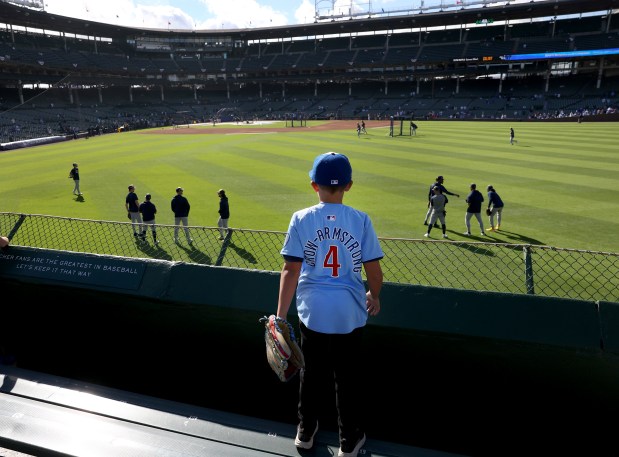 A young fan takes in batting practice from the center field bleachers before Game 3 of the NL Division Series between the Cubs and the Brewers at Wrigley Field in Chicago on Oct. 8, 2025. (Chris Sweda/Chicago Tribune)