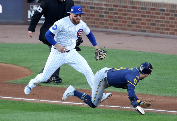 Chicago Cubs first baseman Michael Busch pursues Milwaukee Brewers baserunner Caleb Durbin before Durbin was tagged out during a rundown in the fourth inning of Game 3 of the NL Division Series at Wrigley Field in Chicago on Oct. 8, 2025. (Chris Sweda/Chicago Tribune)