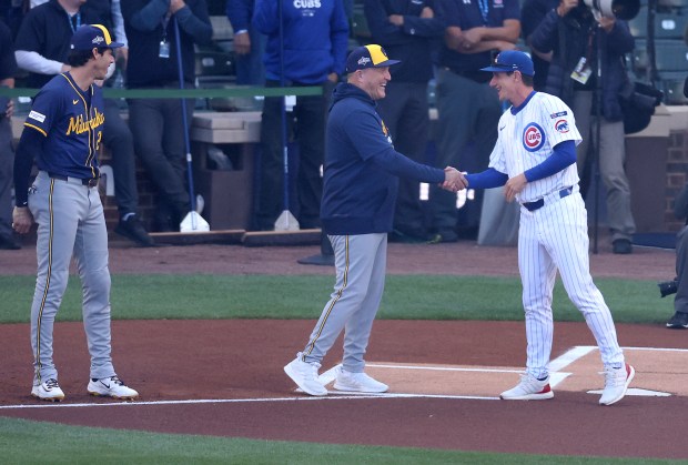 Brewers manager Pat Murphy, center, and Cubs manager Craig Counsell...