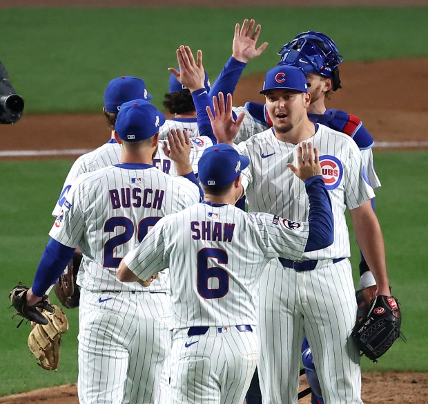 Chicago Cubs relief pitcher Brad Keller and his teammates celebrate...