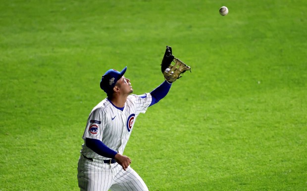 Chicago Cubs right fielder Seiya Suzuki catches a fly ball...