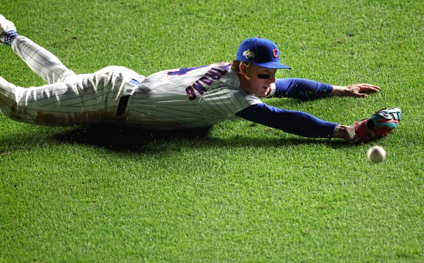 Chicago Cubs center fielder Pete Crow-Armstrong is unable to catch...