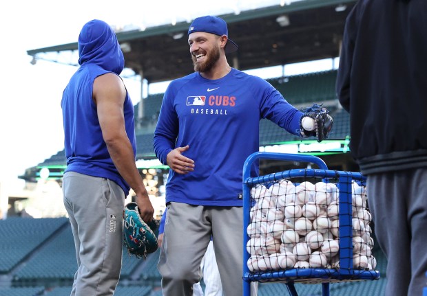Cubs first baseman Michael Busch laughs as players warm up for Game 4 of the NL Division Series between the Cubs and the Milwaukee Brewers at Wrigley Field in Chicago on Oct. 9, 2025. (Chris Sweda/Chicago Tribune)