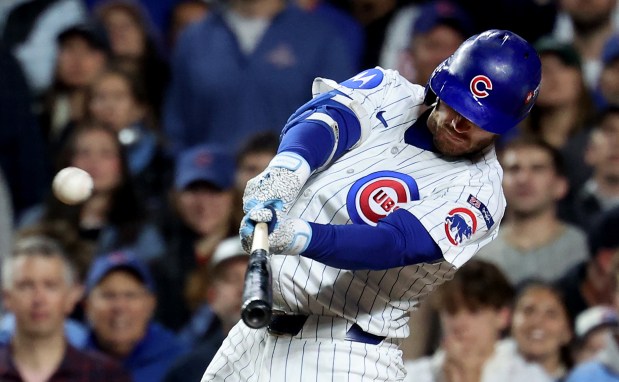 Cubs left fielder Ian Happ hits a three-run home run in the first inning of Game 4 of the NL Division Series against the Brewers at Wrigley Field in Chicago on Oct. 9, 2025. (Chris Sweda/Chicago Tribune)