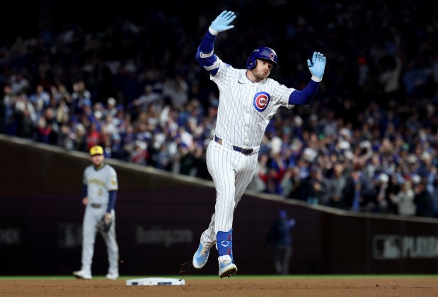 Chicago Cubs left fielder Ian Happ celebrates as he rounds the bases after hitting a three-run home run in the first inning of Game 4 of the NL Division Series against the Milwaukee Brewers at Wrigley Field in Chicago on Oct. 9, 2025. (Chris Sweda/Chicago Tribune)