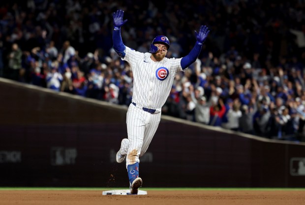 Chicago Cubs first baseman Michael Busch celebrates as he rounds...