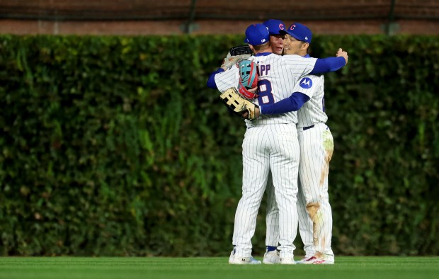 Chicago Cubs outfielders Ian Happ, Pete Crow-Armstrong and Seiya Suzuki celebrate after their Game 4 victory over the Milwaukee Brewers in the NL Division Series at Wrigley Field in Chicago on Oct. 9, 2025. (Chris Sweda/Chicago Tribune)