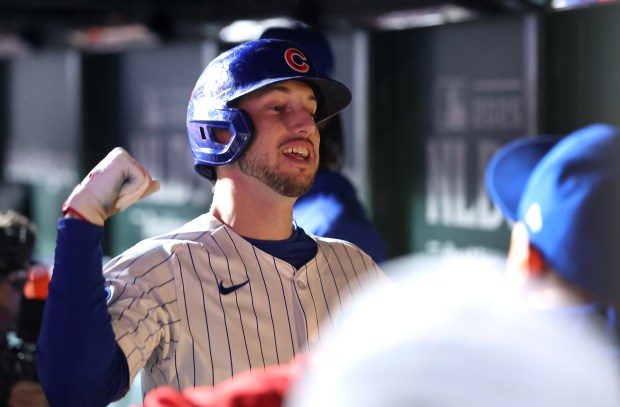 Cubs designated hitter Kyle Tucker is congratulated by his teammates...