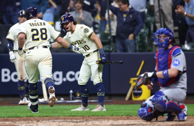Brewers first baseman Andrew Vaughn is congratulated by teammate Sal...