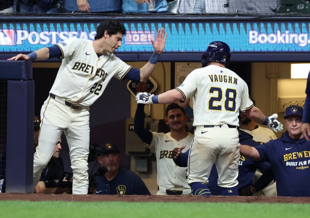 Milwaukee Brewers first baseman Andrew Vaughn is congratulated after hitting...