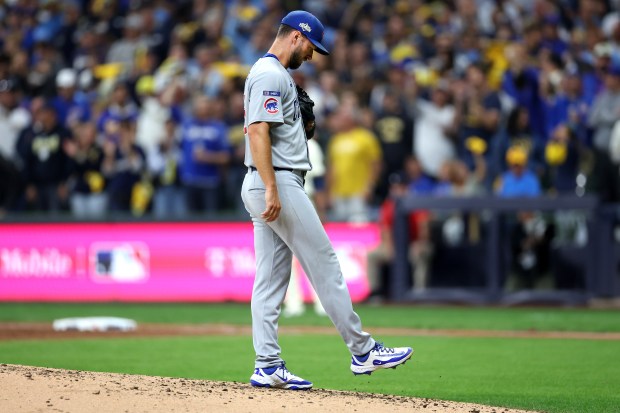 Chicago Cubs relief pitcher Colin Rea reacts on the mound...