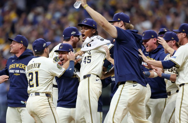 Milwaukee Brewers relief pitcher Abner Uribe (45) celebrates with his...