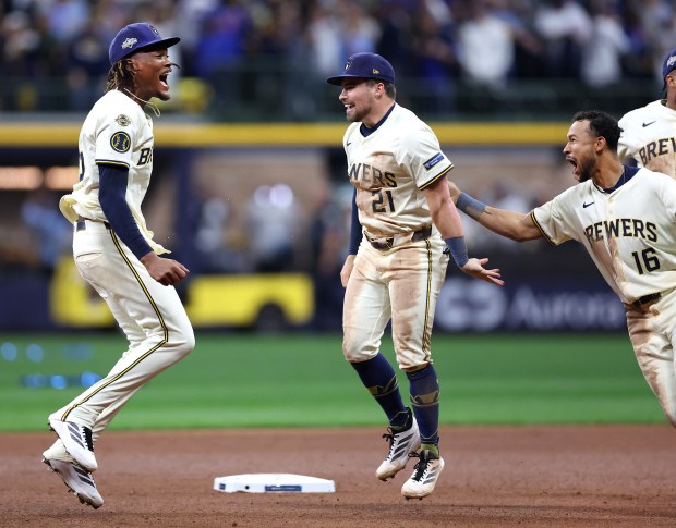 Brewers reliever Abner Uribe, left, third baseman Caleb Durbin (21)...