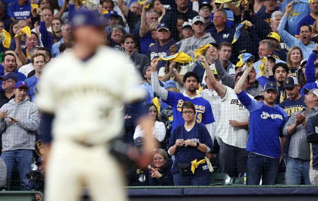 Milwaukee Brewers fans cheer as relief pitcher Chad Patrick (39)...