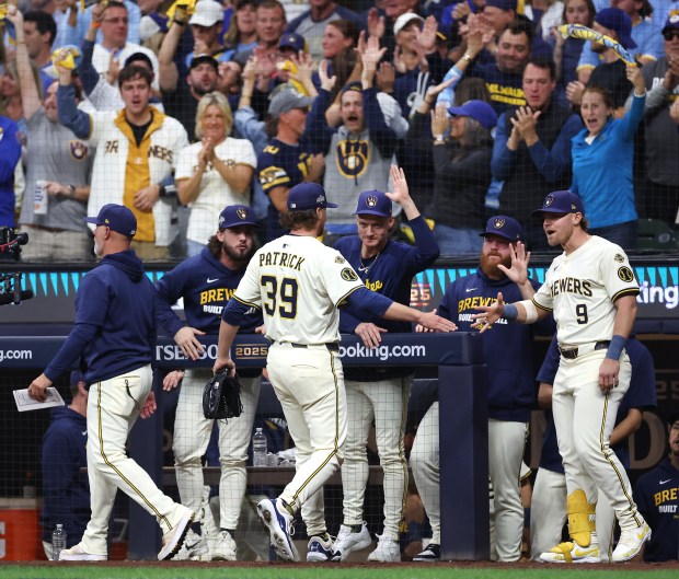 Milwaukee Brewers relief pitcher Chad Patrick (39) is congratulated by...