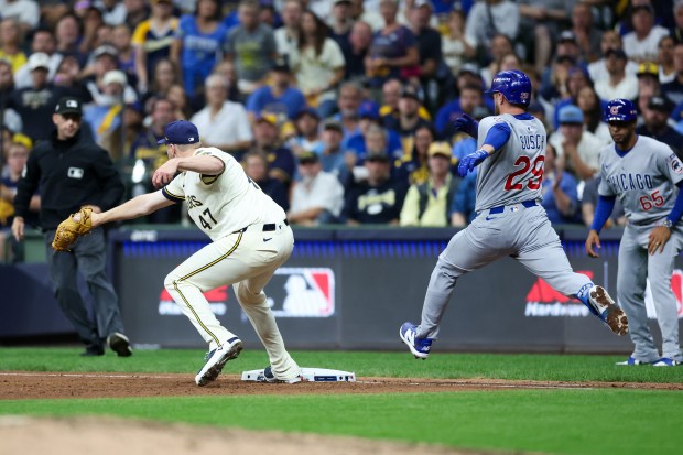 Milwaukee Brewers pitcher Jared Koenig (47) tags out Chicago Cubs...