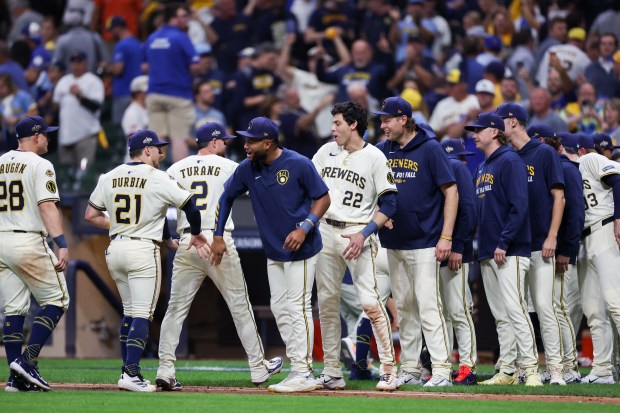 Milwaukee Brewers players celebrate after defeating the Chicago Cubs, 7-3,...