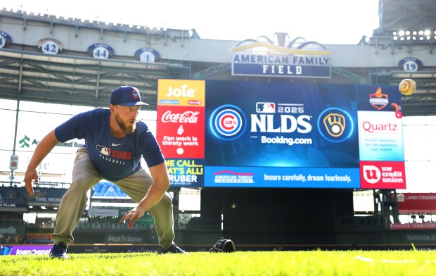 Chicago Cubs first baseman Michael Busch warms up for the...