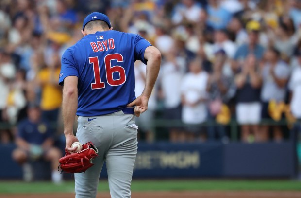 Chicago Cubs starting pitcher Matthew Boyd (16) walks back to...
