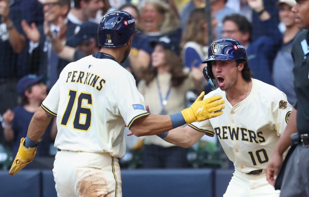 The Brewers' Blake Perkins (16) and Sal Frelick celebrate after...