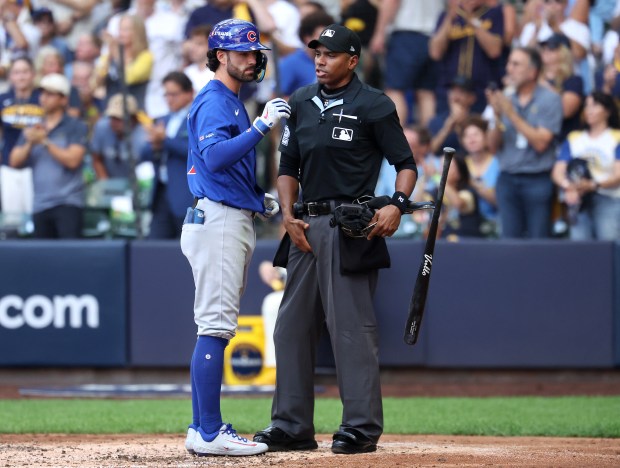 Chicago Cubs shortstop Dansby Swanson (7) tosses his bat aside...
