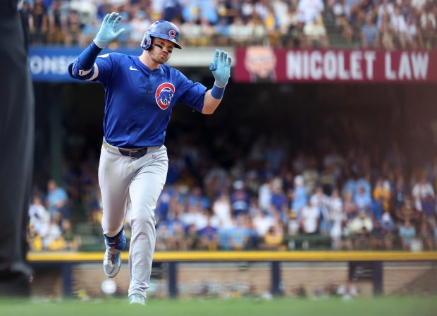 Chicago Cubs left fielder Ian Happ (8) rounds the bases...