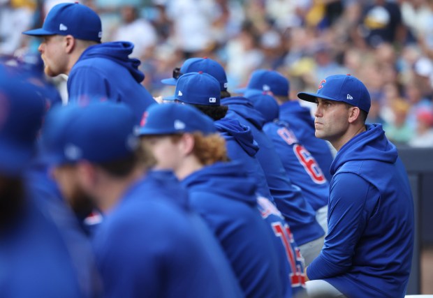 Chicago Cubs starting pitcher Matthew Boyd watches from the dugout...